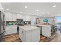 Bright, updated kitchen features white cabinets, stainless appliances, and a large center island at 690 Island Way # 1003, Clearwater Beach, FL 33767