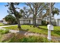 Quaint single-story home with mature trees shading the front yard and driveway at 7236 65Th N Way, Pinellas Park, FL 33781