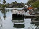 Pontoon boat at a dock in the water, offering a relaxing waterfront experience at 8117 River Point Dr, Weeki Wachee, FL 34607