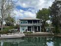Charming two-story waterfront home with a dock, boat, and lovely outdoor space at 8117 River Point Dr, Weeki Wachee, FL 34607