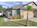 Charming single-Gathering home featuring an attached two-car garage and fresh landscaping at 8949 Southern Charm Cir, Brooksville, FL 34613