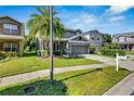 Charming two-story home with a well-maintained lawn and a view of the neighborhood at 9010 Grand Bayou Ct, Tampa, FL 33635