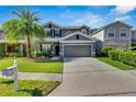 Charming two-story home featuring a well-maintained lawn and inviting curb appeal at 9010 Grand Bayou Ct, Tampa, FL 33635