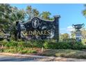 Elegant GlenLakes community entrance sign surrounded by lush landscaping and colorful flower beds at 9376 French Quarters Cir, Weeki Wachee, FL 34613