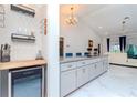 Kitchen with wine storage area, granite countertops, and an open layout leading to the living area at 9376 French Quarters Cir, Weeki Wachee, FL 34613