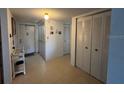 Entryway with tile flooring features a coat closet and additional closet with sliding doors at 9815 47Th N Ave # 303, St Petersburg, FL 33708