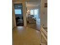 Open living room with sliding doors to the lanai and entryway to the bedroom at 9815 47Th N Ave # 303, St Petersburg, FL 33708