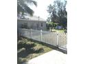 White picket fence surrounds the yard, adding charm and security to the property's exterior at 4905 Court St, Zephyrhills, FL 33541