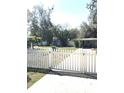 A white picket fence with a gate encloses the yard, adding to the property's charm and curb appeal at 4905 Court St, Zephyrhills, FL 33541
