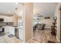 Open-concept kitchen featuring white cabinets, stainless steel appliances, and granite countertops at 11414 Coconut Island Dr, Riverview, FL 33569