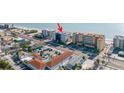 This aerial shot shows a condo near the beach, a parking lot, and surrounding businesses at 14700 Gulf Blvd # 405, Madeira Beach, FL 33708