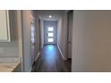 Bright hallway with a clear view of the front door, showcasing natural light and an open floor plan at 17036 James Trl, Parrish, FL 34219