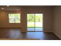 Living room featuring sliding glass doors that provide access to the patio and a beautiful backyard view at 17036 James Trl, Parrish, FL 34219