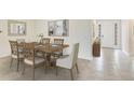 Elegant dining room with wood table, seating for six, and neutral decor at 17118 James Trl, Parrish, FL 34219