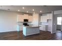 Bright kitchen featuring stainless appliances, granite countertops, and a center island at 1741 Cobb Trl, Parrish, FL 34219