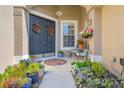 Inviting front porch with stylish decorations, plants, and seating area that adds to its charm at 182 Dahoon Ct, Spring Hill, FL 34609