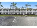 Exterior of condo complex with parking and lush landscaping with palm trees at 211 Brandy Wine Dr # 211, Largo, FL 33771