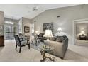 Cozy living room with stylish furniture, neutral color scheme, and access to other rooms at 2343 Hidden Trail Dr, Spring Hill, FL 34606