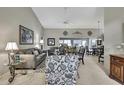 Bright living room featuring high ceilings, neutral tones, comfortable seating, and lots of natural light at 2343 Hidden Trail Dr, Spring Hill, FL 34606