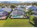 Aerial view of home's large screened patio area, inground pool, and beautiful backyard at 31101 Wrencrest Dr, Wesley Chapel, FL 33543