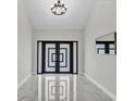 Bright foyer features a modern front door design and elegant marble flooring at 4520 Pine Hollow Dr, Tampa, FL 33624