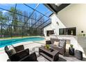 Screened-in pool area with an outdoor kitchen and comfortable lounge furniture at 4520 Pine Hollow Dr, Tampa, FL 33624