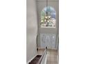Bright foyer with a large window and an elegant chandelier illuminating the entryway at 5337 Treig Ln, Wesley Chapel, FL 33545