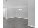 Spacious living room with herringbone floors, a modern light fixture, and neutral paint at 5440 Quist Dr, Port Richey, FL 34668