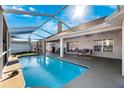 Relaxing screened-in pool area with ample seating and outdoor dining space for enjoyable outdoor living at 5815 Dory Way, Tampa, FL 33615