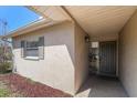 Charming entrance with a decorative flower basket, inviting guests into this lovely home at 7437 118Th Dr, Largo, FL 33773