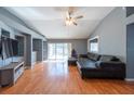 Spacious living room features gleaming hardwood floors and sliding glass doors to the pool at 9415 Pebble Glen Ave, Tampa, FL 33647