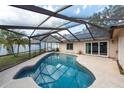 Inviting in-ground pool with screened enclosure and spacious patio for entertaining at 9415 Pebble Glen Ave, Tampa, FL 33647
