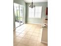 Bright dining area with tile flooring and access to the screened-in patio at 11477 Tinder Ct, Venice, FL 34292