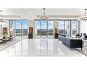 Bright living room featuring tile floors, modern chandeliers, and stunning views from floor-to-ceiling windows at 1209 E Cumberland Ave # 2802, Tampa, FL 33602