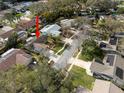 Neighborhood aerial view showing home with solar panels in a tree covered neighborhood at 1363 Overlea Dr, Dunedin, FL 34698