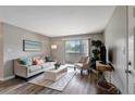 Bright living room with hardwood floors, neutral decor, and sliding glass doors to a balcony at 1400 Gandy N Blvd # 502, St Petersburg, FL 33702