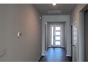 Bright entryway featuring hard surface floors and a modern front door with multiple windows at 17045 James Trl, Parrish, FL 34219