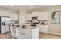 Modern kitchen featuring granite countertops, stainless steel appliances and barstool seating at 17057 James Trl, Parrish, FL 34219