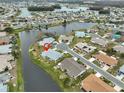 Beautiful waterfront community with lush landscaping and mature trees surrounding a well-maintained home at 1805 Columbine Pl, Sun City Center, FL 33573