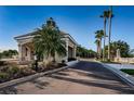 Community entrance featuring stone and stucco construction, a guard house, and mature landscaping at 18186 Sandy Pointe Dr, Tampa, FL 33647