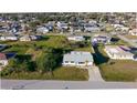 Aerial view of a home with a well-maintained lawn and a driveway at 184 Garden Nw Ave, Port Charlotte, FL 33952