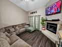 Comfortable living room featuring hardwood floors, fireplace, and ample natural light at 1988 Georgia S Cir, Clearwater, FL 33760