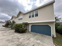 Inviting townhome showcasing a private garage and complemented by tropical landscaping at 2900 W Azeele St # H, Tampa, FL 33609