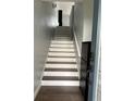 Inviting staircase with hardwood treads, white risers, and modern accents at 2900 W Azeele St # H, Tampa, FL 33609