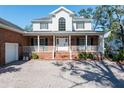Inviting brick home with a charming front porch, brick stairs and meticulously maintained landscaping at 4315 W Cleveland St, Tampa, FL 33609