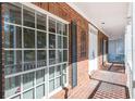 Covered brick front porch with classic white railings and trim, offering a welcoming entrance at 4315 W Cleveland St, Tampa, FL 33609
