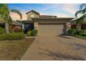 Inviting single-Gathering home boasts a two-car garage, well-manicured landscaping, and a screened-in porch at 4968 Reflecting Pond Cir, Wimauma, FL 33598