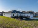 Exterior of a well-maintained home featuring a manicured lawn and clean architectural lines at 5433 Chestnut Ridge Rd, Dade City, FL 33523
