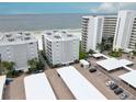 Beautiful low-angle shot of modern condo buildings with covered parking and well-maintained landscaping at 6310 Midnight Pass Rd # 204N, Sarasota, FL 34242