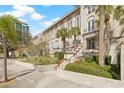 Exterior shot of a multi-story building featuring lush landscaping and mature palm trees at 701 Mirror Lake N Dr # 216, St Petersburg, FL 33701